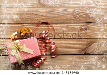 Christmas presents with snow crystal on wooden table background.