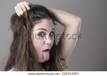 Portrait of a young brunette woman making faces with different expressions and emotions