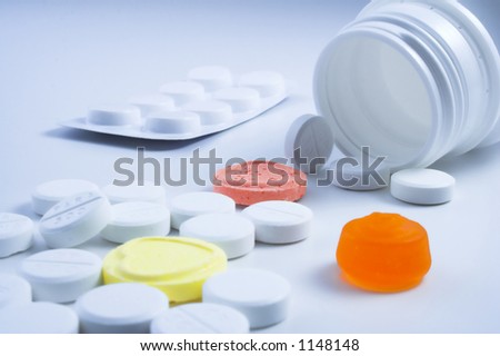 Bottle of pills mixed with sweets.Concept - Keep out of reach of children.