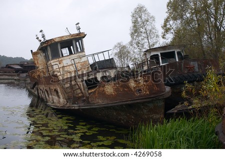 blasted rusty boat in the river near of Chernobyl