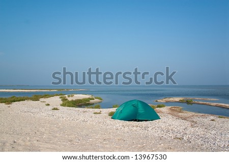 Lonely tent on the sandbank at seaside