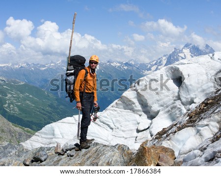 mountain-climber in high mountains with glacier at background
