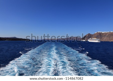 Wake (propeller wash) from a cruise ship with Greek island in the horizon