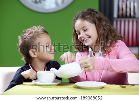 Happy children in cafe.The little boy and his elder sister