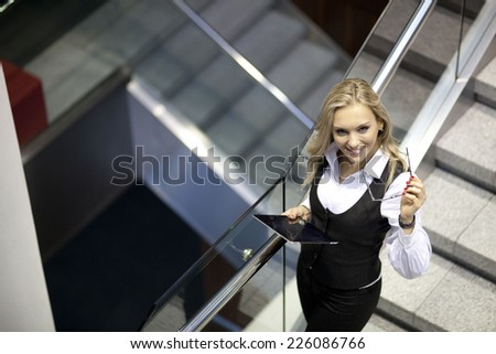 A pretty business woman walking down the stairs