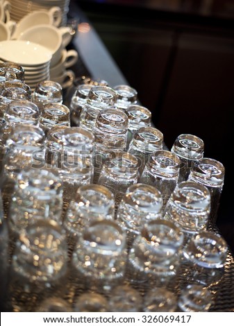Series of inverted empty wine glasses arranged in several rows. the focus in the center of the frame