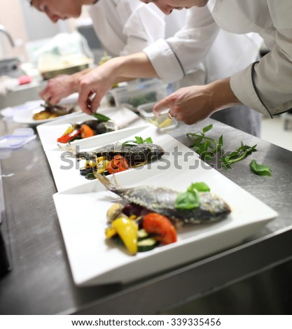 Busy chefs at work in the restaurant kitchen