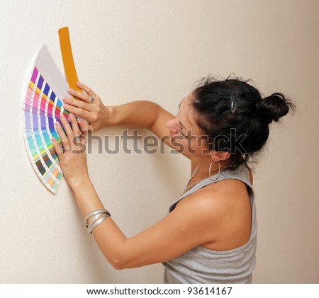 woman select a color to paint her wall