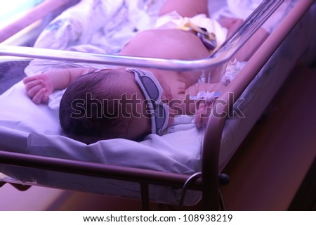 This African-American newborn is being treated for jaundice. Ultra violet light therapy is a common treatment for jaundice.