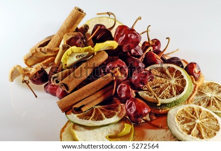 autumn composition with different dried fruit and vegetable: lemon, orange, cayenne and cinnamon