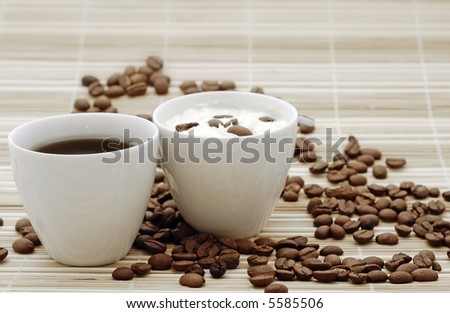 coffee for two: cup of black coffee and cup of coffee with cream with beans