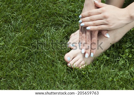 woman hands and foot on grass