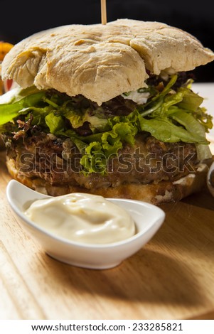big hamburger with potatoes and ketchup