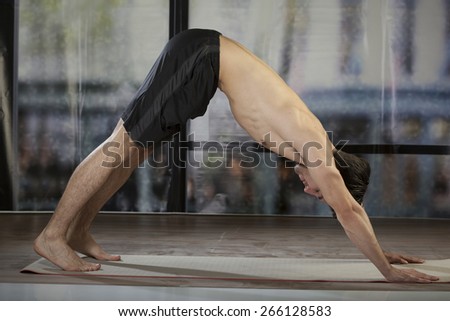 young man doing yoga in office