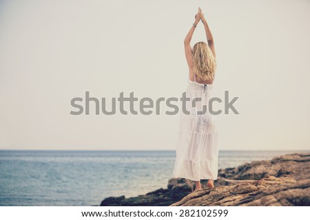 woman relaxing on beach trough an retro photo filter