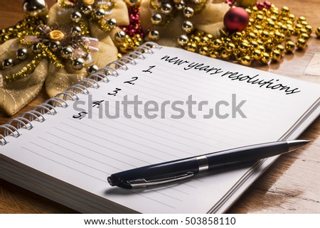 New Year\'s resolutions on a wooden table with colorful decorations. 2017