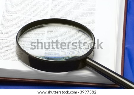 magnifying glass on a book - close-up