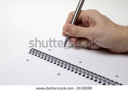 A man about to write on a pad with plenty of room for copy.
