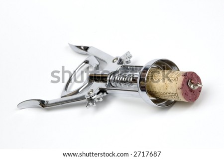 A corkscrew piercing a red wine cork 