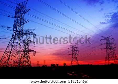 Silhouette electricity pylons during sunset