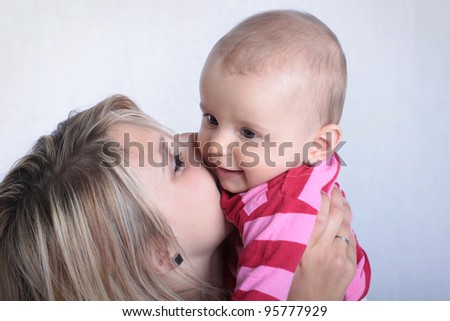 Mother kissing happy baby