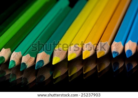 Palette of color pencils on a black background.