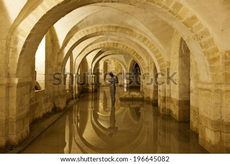 Winchester, Hampshire, UK - May 15, 2014: The flooded Crypt of Winchester Cathedral containing the sculpture \