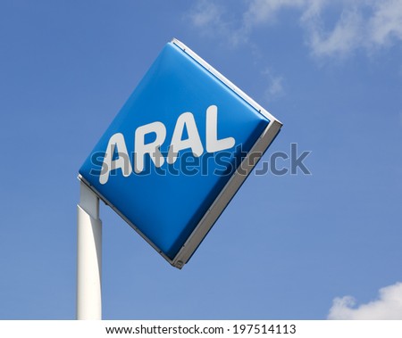 Hamburg, Germany - May 23, 2011: ARAL logo on post at a gas station against blue sky with small clouds. ARAL is a brand of BP p.l.c, the third largest energy company worldwide.