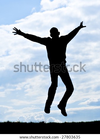 silhouette of young man jumping for joy