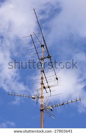 radio and television antenna against blue sky