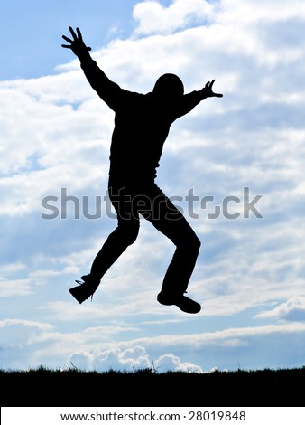 silhouette of young man jumping for joy
