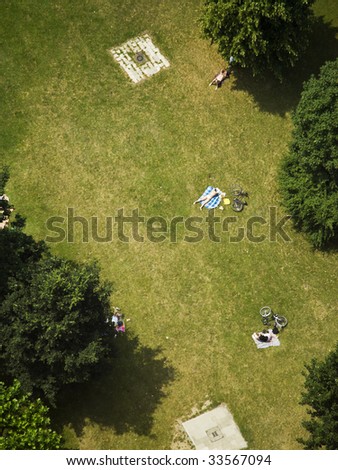 several people sunbathing on lawn on park, birds view