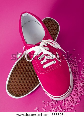 pink sneakers on purple background