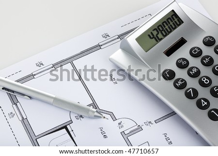 mechanical pencil and calculator on blueprint of floor plan