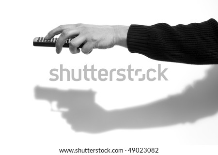 hand using remote control, casting the shadow of a hand with a gun