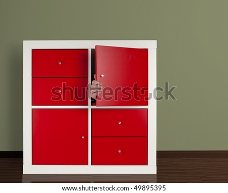 hand closing door of cabinet from the inside