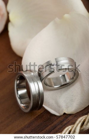 stock photo silver or platinum wedding rings with diamond on light pink