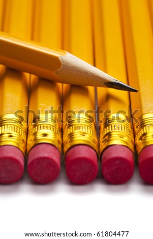 close up of sharp pencil tip on row of yellow pencils