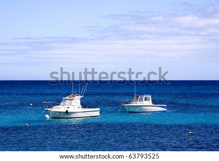 two white motor boats on blue sea under summer sky