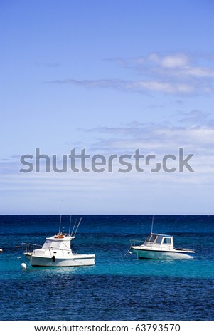 two white motor boats on blue sea under summer sky