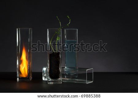 The four elements - Fire, water, earth and air - arranged in glass vases