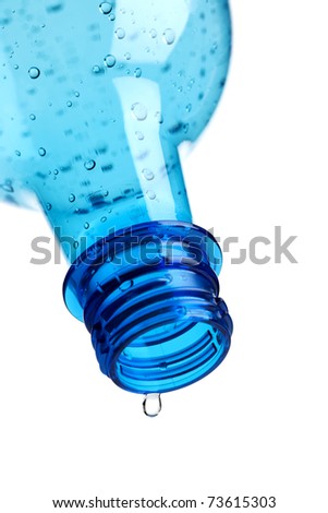 single drop dripping from empty water bottle