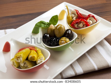 variety of antipasti  - red and green peppers stuffed with goat cheese, black olives and green olives with almonds