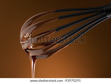 liquid chocolate topping on a whisk