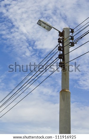 Electric poles on  street during the day.