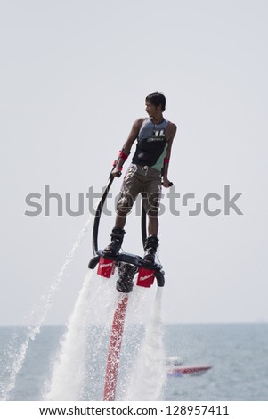CHONBURI, THAILAND-DECEMBER 8: Unidentified man showing usage water machine flyboard in Jet Ski King\'s Cup - World Cup Grand Prix 2012 at Jomtien Beach Pattaya on December 8,2012 in Chonburi, Thailand