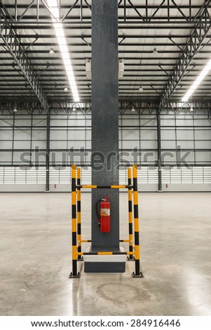Fire extinguisher in the empty warehouse.