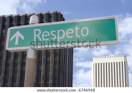 Street sign with an arrow and the Spanish word \