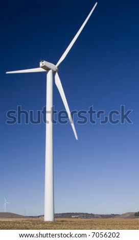 Wind turbines standing in a field in central Spain.