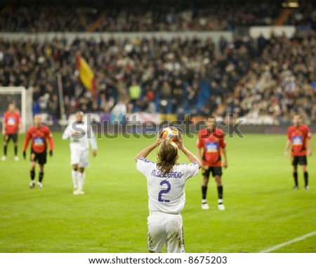 Player makes a throw in during a football (soccer) game in Madrid